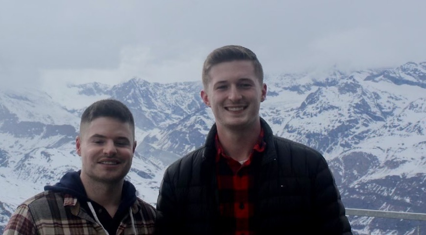 Joel and Owen together on the Gornergrat above Zermatt, Switzerland, with snow covered peaks behind them.